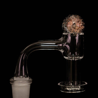 Dichro glass 22 mm bubble carb cap in pink, on a quartz banger