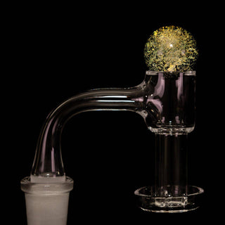 Dichro glass 22 mm bubble carb cap in yellow, on a quartz banger