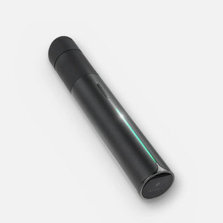 Puffco Pivot in black, angled view with the green light bar on